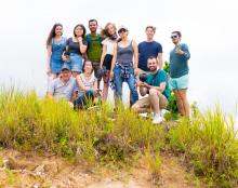 Team in casual clothing with equipment outside on hill with tall grasses. Front, from left, Penn professor Peter Decherney, camera operator Erica Liu, senior Arman Murphy. Back, from left: May graduate Vanita Flanagan, junior Ericka Lu, camera operator Enrique Unzueta-Miranda, junior Melisande McLaughlin, alumna Jean Lee, sophomore Alec Escobar, and local producer Armig Santos.