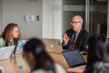 Wallace speaks to student in conference room