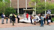 Over two dozen students, faculty, and local residents gathered on Monday in front of the Button with signs supporting Penn Book Center