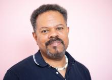 headshot of John Keene in front of pink background