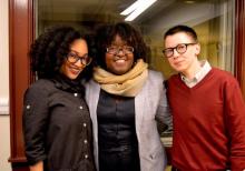 Tonya Foster, Amber Rose Johnson, and Davy Knittle stand with arms wrapped, smiling, in front of glass interior window