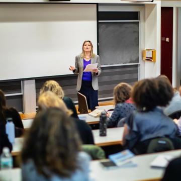Jennifer Egan lectures from front of classroom